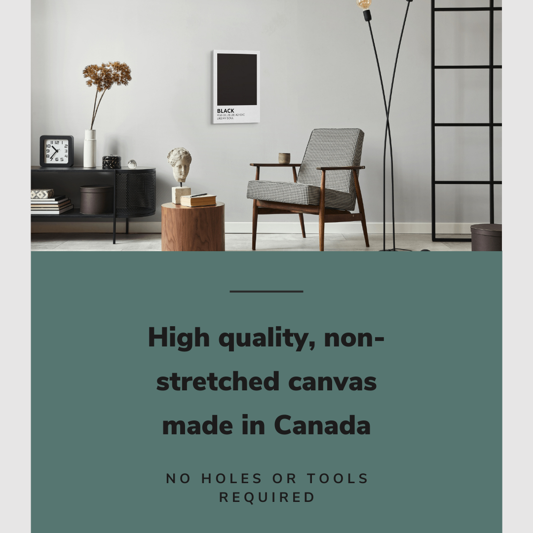 Lifestyle image of the vertical, 16x24 inch easy to hang canvas wall art hung in a living room above an accent chair and side table with graphic saying "High quality, non-stretched canvas made in Canada"
