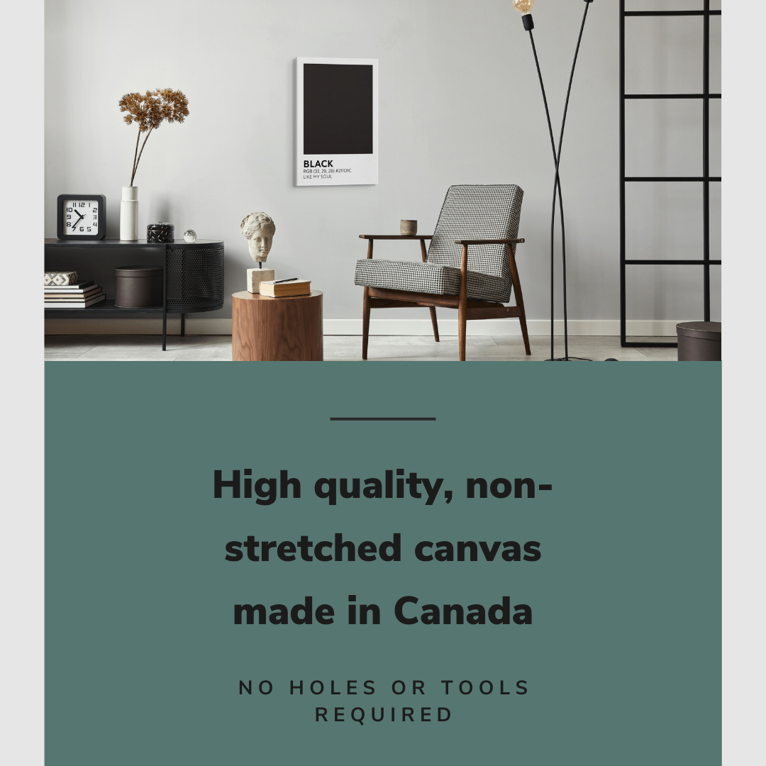 Lifestyle image of the vertical, 20x30 inch easy to hang canvas wall art hung in a living room above an accent chair and side table with graphic saying "High quality, non-stretched canvas made in Canada"