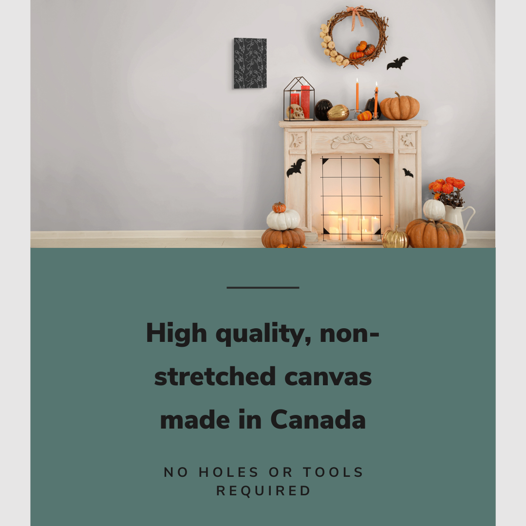 Lifestyle image of the vertical, 12x18 inch easy to hang canvas wall art hung in a living room beside a fireplace decorated with Halloween decorations with graphic saying "High quality, non-stretched canvas made in Canada"