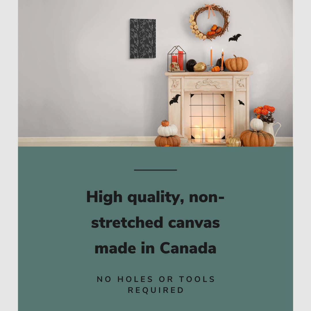 Lifestyle image of the vertical, 16x24 inch easy to hang canvas wall art hung in a living room beside a fireplace decorated with Halloween decorations with graphic saying "High quality, non-stretched canvas made in Canada"