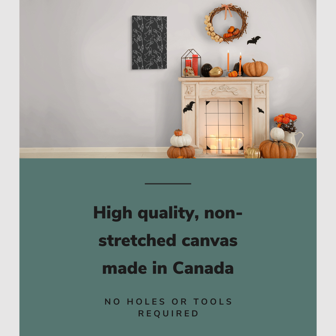 Lifestyle image of the vertical, 20x30 inch easy to hang canvas wall art hung in a living room beside a fireplace decorated with Halloween decorations with graphic saying "High quality, non-stretched canvas made in Canada"