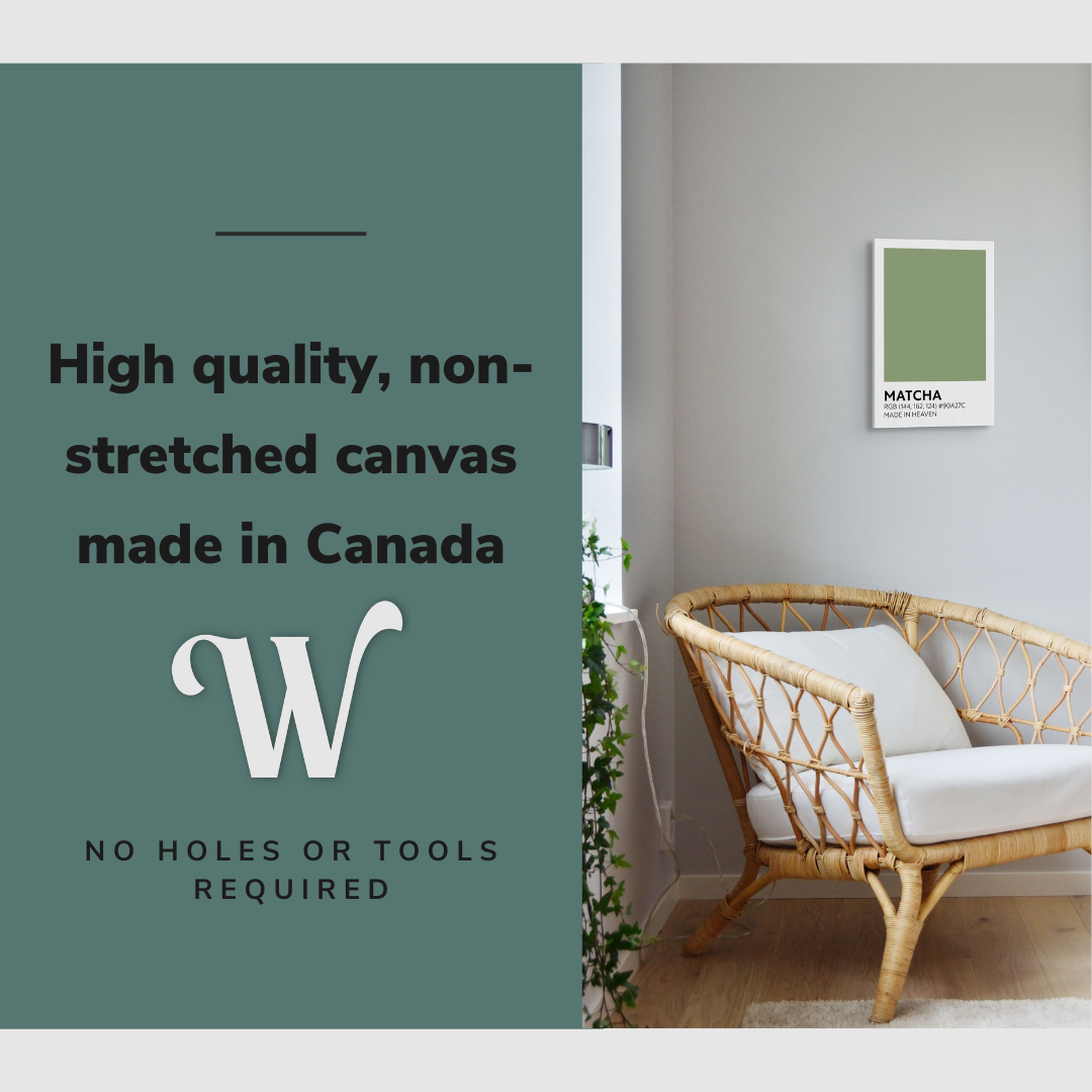 Lifestyle image of the vertical, 12x18 inch easy to hang canvas wall art hung in a living room above an accent chair and beside a window with plants with graphic saying "High quality, non-stretched canvas made in Canada"