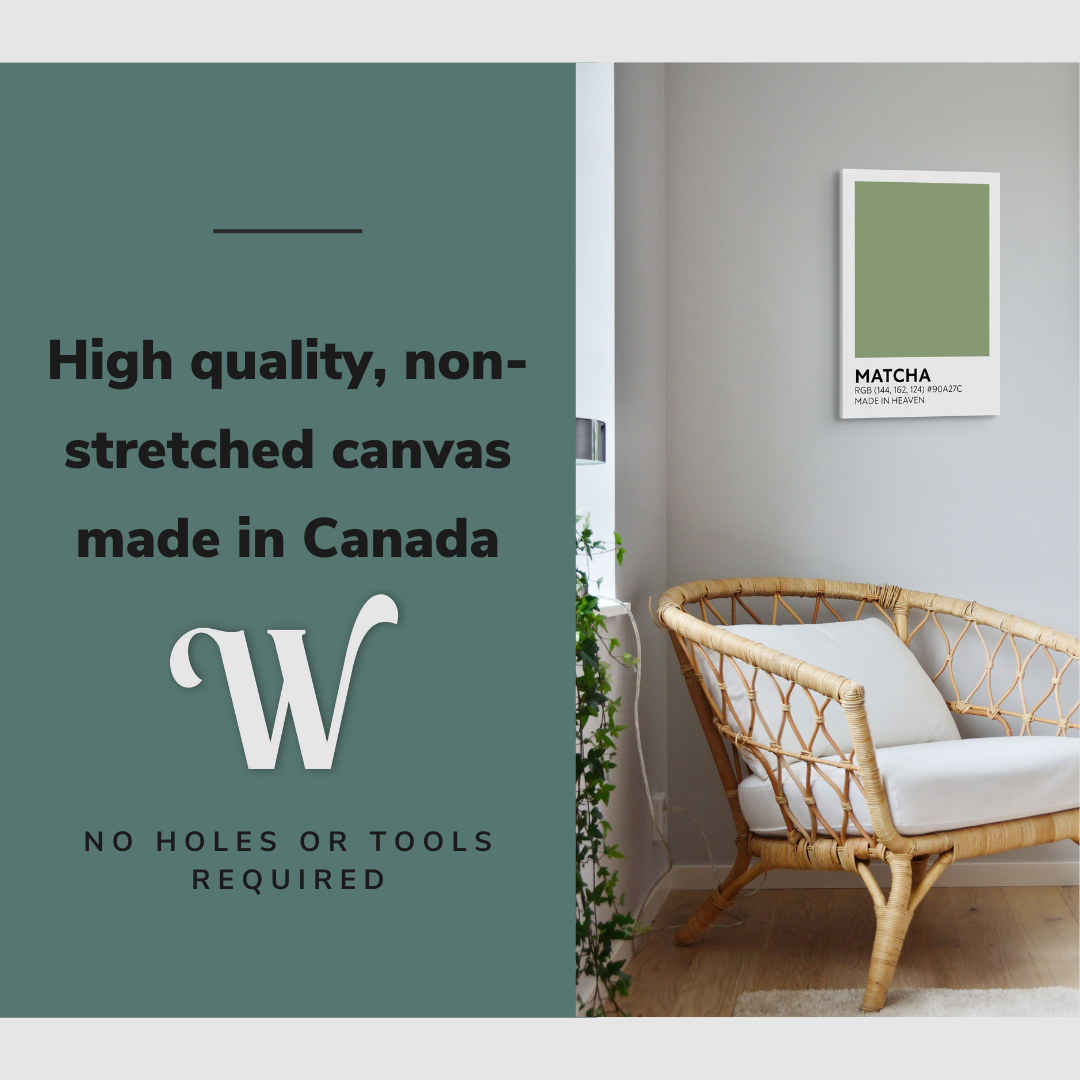 Lifestyle image of the vertical, 16x24 inch easy to hang canvas wall art hung in a living room above an accent chair and beside a window with plants with graphic saying "High quality, non-stretched canvas made in Canada"