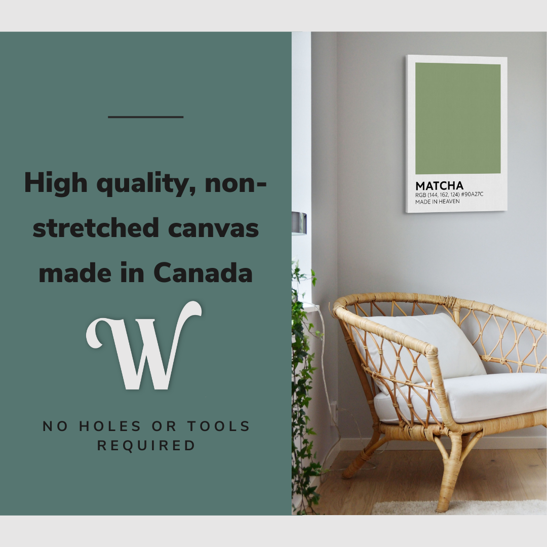 Lifestyle image of the vertical, 20x30 inch easy to hang canvas wall art hung in a living room above an accent chair and beside a window with plants with graphic saying "High quality, non-stretched canvas made in Canada"