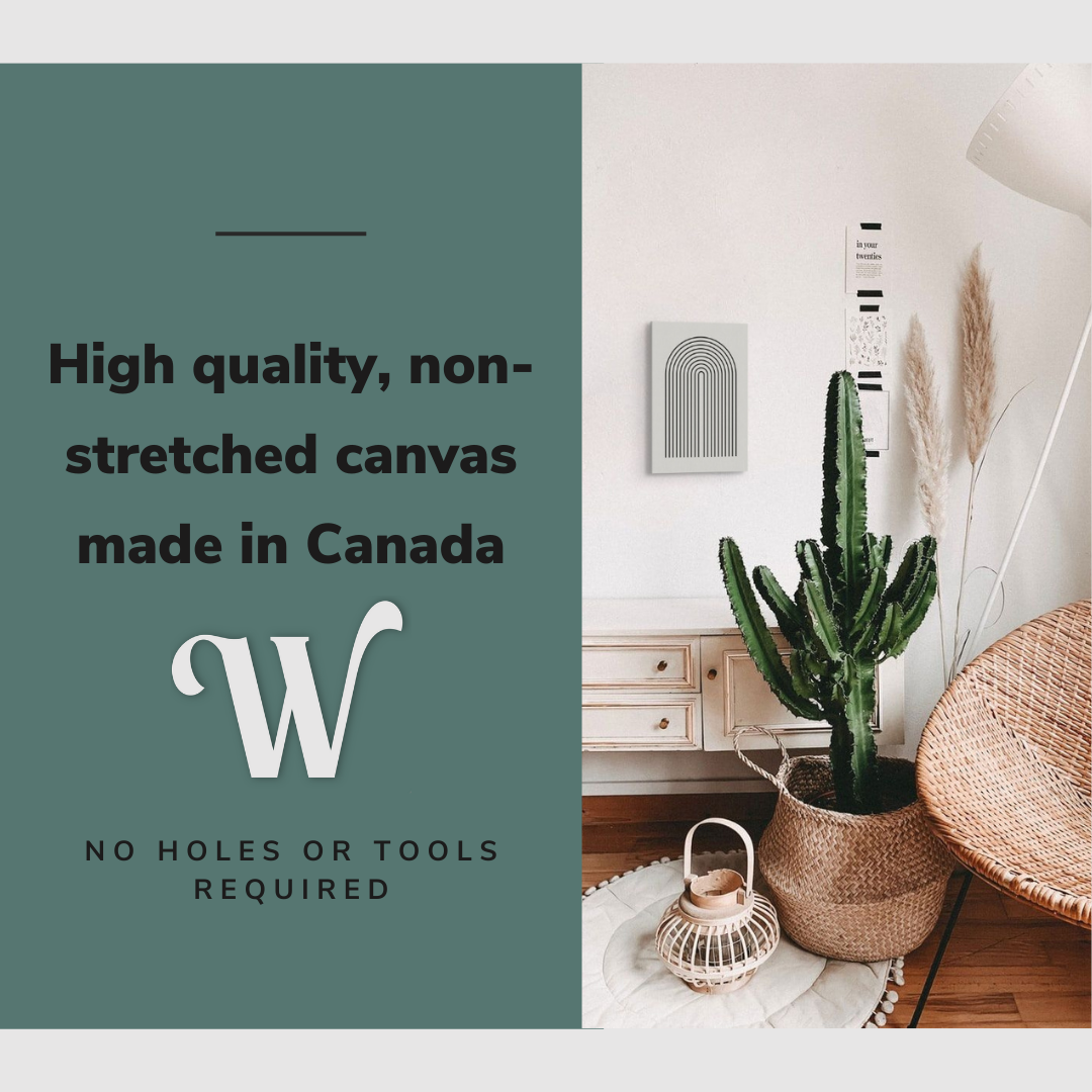 Lifestyle image of the vertical, 12x18 inch easy to hang canvas wall art hung in a bedroom beside a cactus and accent chair with graphic saying "High quality, non-stretched canvas made in Canada"