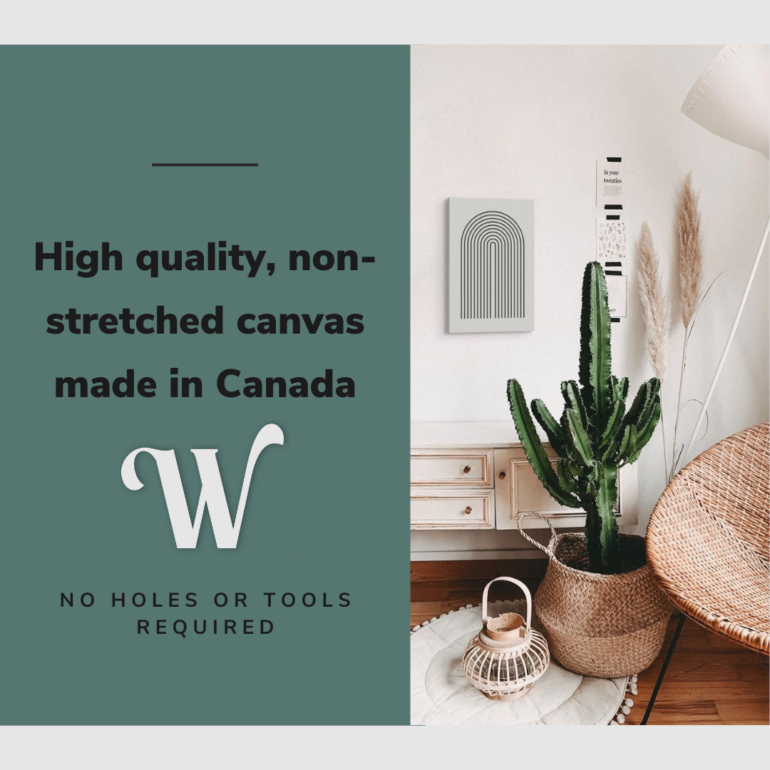 Lifestyle image of the vertical, 16x24 inch easy to hang canvas wall art hung in a bedroom beside a cactus and accent chair with graphic saying "High quality, non-stretched canvas made in Canada"