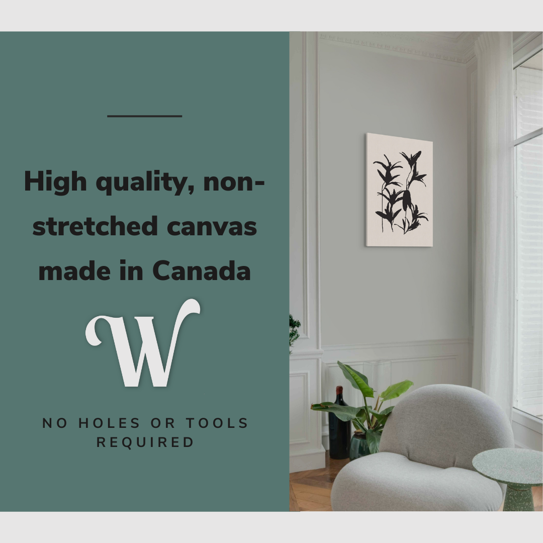Lifestyle image of the vertical, 20x30 inch easy to hang canvas wall art hung in a living room above an accent chair and a coffee table with graphic saying "High quality, non-stretched canvas made in Canada"