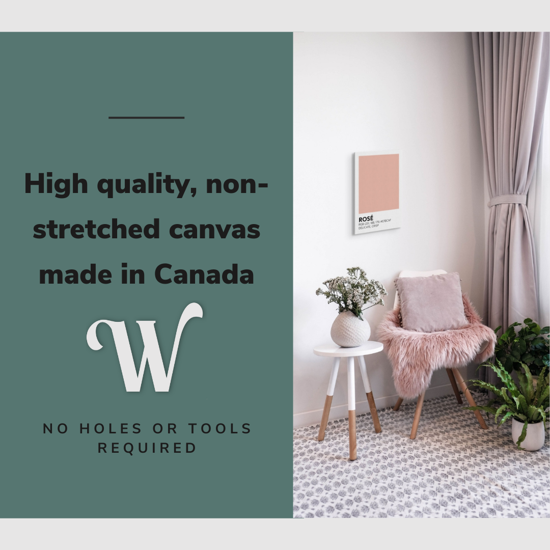 Lifestyle image of the vertical, 12x18 inch easy to hang canvas wall art hung in a living room above an accent chair and side table with graphic saying "High quality, non-stretched canvas made in Canada"
