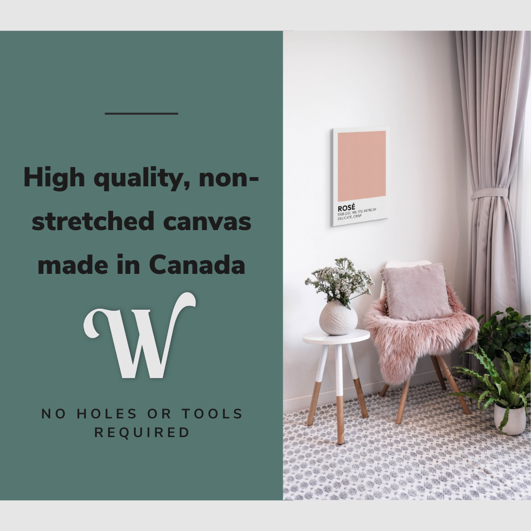 Lifestyle image of the vertical, 16x24 inch easy to hang canvas wall art hung in a living room above an accent chair and side table with graphic saying "High quality, non-stretched canvas made in Canada"