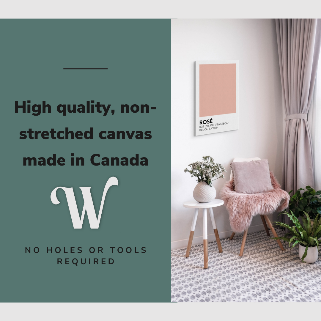 Lifestyle image of the vertical, 20x30 inch easy to hang canvas wall art hung in a living room above an accent chair and side table with graphic saying "High quality, non-stretched canvas made in Canada"