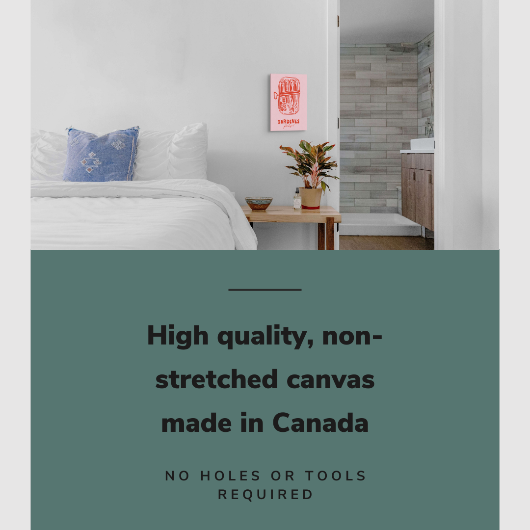 Lifestyle image of the vertical 12x18" inch easy to hang canvas wall art hung above a bed in a coastal themed bedroom overlooking a bathroom with graphic saying "High quality, non-stretched canvas made in Canada"