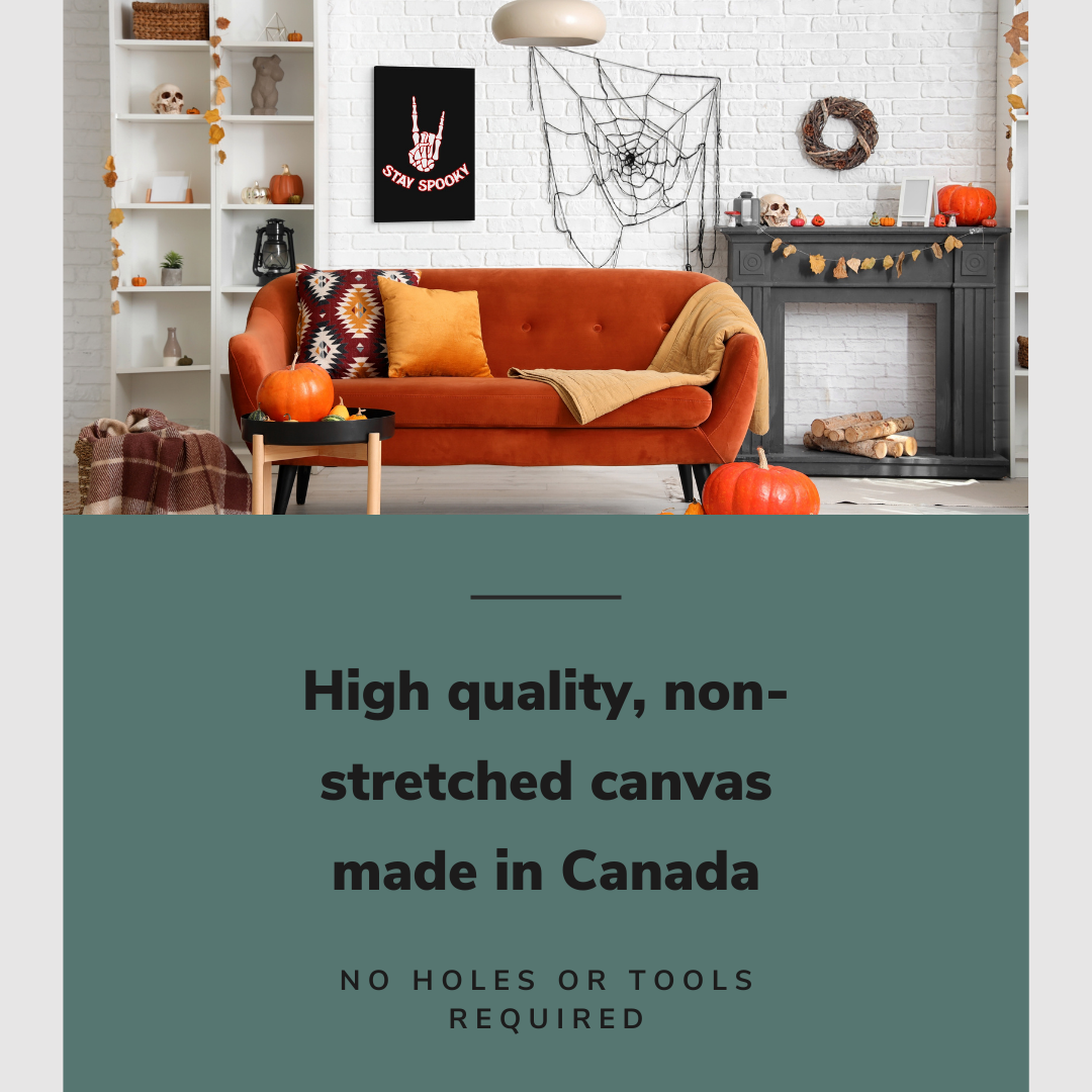 Lifestyle image of the vertical, 20x30” inch easy to hang canvas wall art hung in a living room decorated with Halloween items above a couch beside a fireplace with graphic saying "High quality, non-stretched canvas made in Canada"