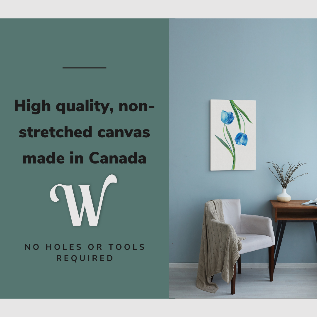 Lifestyle image of the vertical, 16x24 inch easy to hang canvas wall art hung in hung in an minimalist living room above an accent chair with graphic saying "High quality, non-stretched canvas made in Canada"
