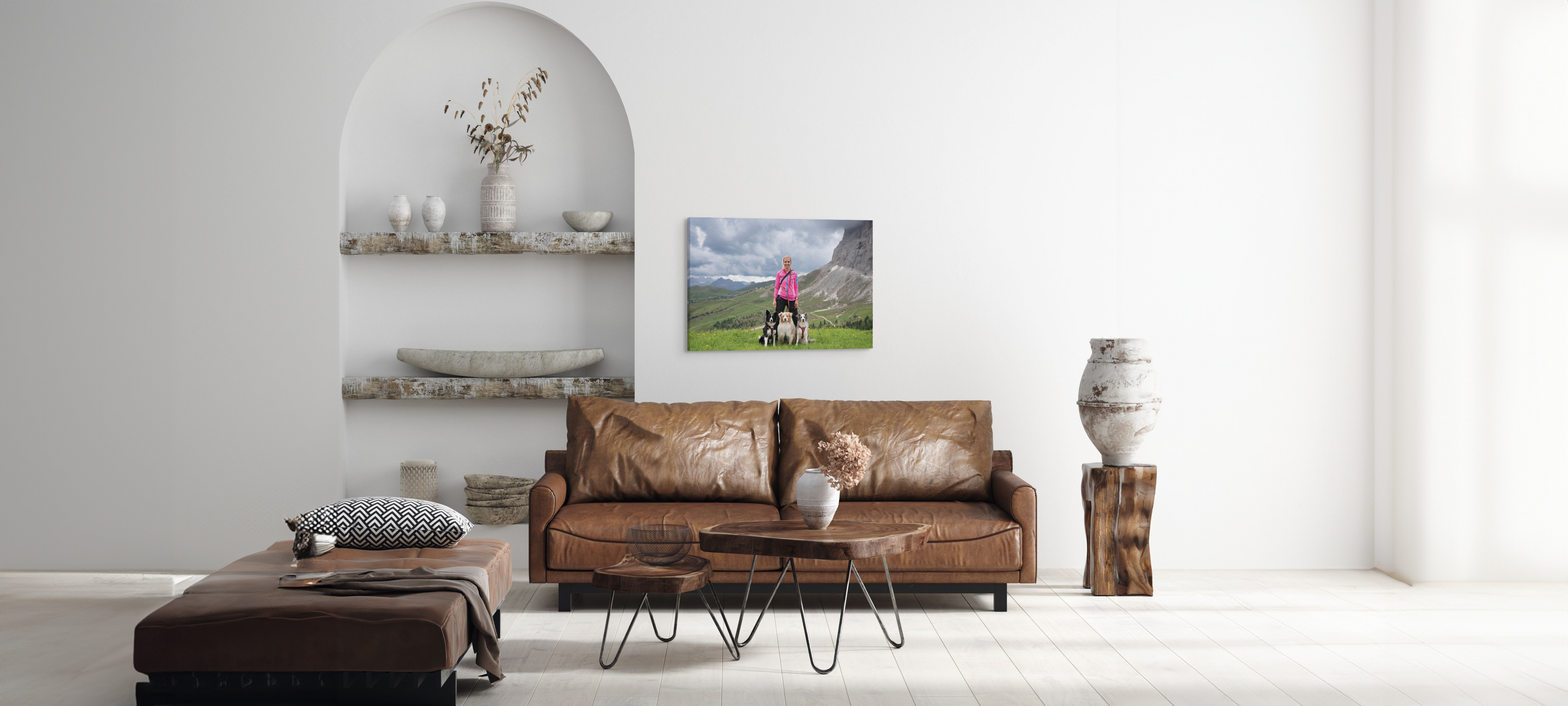 Custom photo of a woman with her dogs at the top of a hike, hung over a living room sofa.