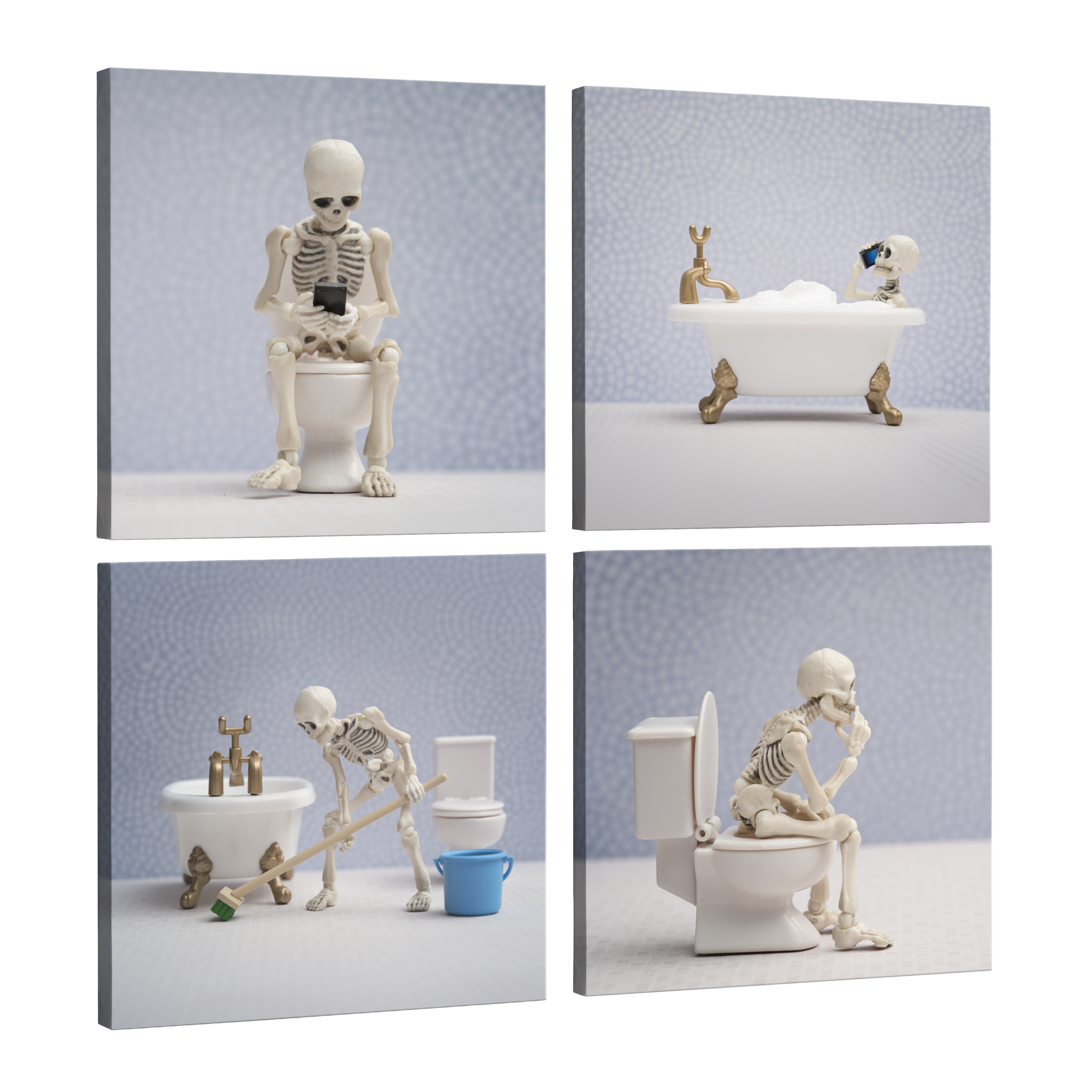 Set of 4, square easy to hang canvas prints on a transparent background featuring images of a miniature skeleton figure photographed in four different bathroom scenarios. One he is sitting on a toilet on his phone, one he is in the bathtub taking a phonecall, one he is cleaning the bathroom with a broom and the last one he is on the toilet pondering. All on a light purple background.