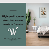 Lifestyle image of the vertical, 20x30" inch easy to hang canvas wall art hung in a coastal styled bedroom above a bed with graphic saying "High quality, non-stretched canvas made in Canada"