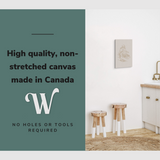 Lifestyle image of the vertical 16x24” inch easy to hang canvas wall art hung in a modern farmhouse kitchen beside a sink with graphic saying "High quality, non-stretched canvas made in Canada."