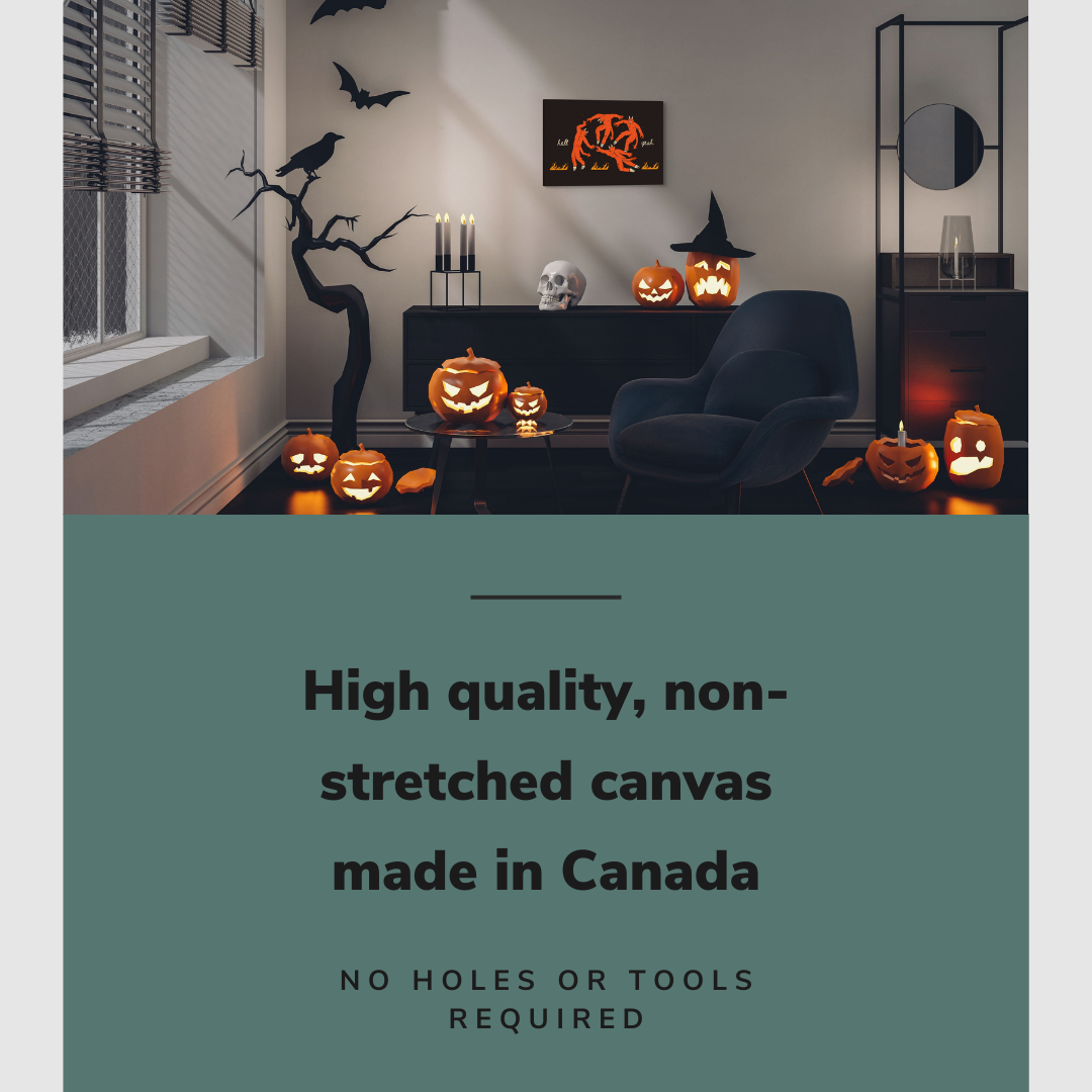 Lifestyle image of the horizontal 16x24” inch easy to hang canvas wall art hung in a Halloween decorated living room above a credenza and a reading chair with graphic saying "High quality, non-stretched canvas made in Canada."