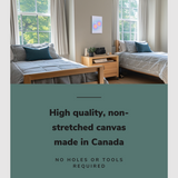 Lifestyle image of the vertical, 12x18 inch easy to hang canvas wall art hung in a dorm bedroom hung between two single beds with graphic saying "High quality, non-stretched canvas made in Canada"