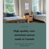 Lifestyle image of the vertical, 16x24 inch easy to hang canvas wall art hung in a dorm bedroom hung between two single beds with graphic saying "High quality, non-stretched canvas made in Canada"