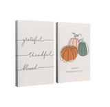 Set of 2, 2:3 vertical easy to hang canvas prints on a transparent background featuring an image of three words in dark grey cursive, "grateful", "thankful", and "blessed" on a light grey background with the second panel having three pumpkins in orange, white and green with "Happy Thanksgiving" under it. 