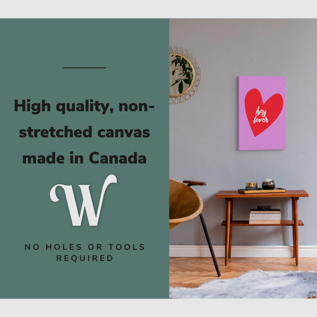 Lifestyle image of the vertical, 16x24 inch easy to hang canvas wall art hung in in a living room above an accent chair and side table beside a mirror with graphic saying "High quality, non-stretched canvas made in Canada"