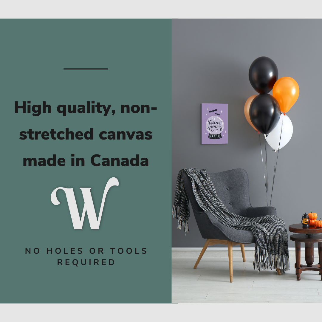 Lifestyle image of the vertical 12x18” inch easy to hang canvas wall art hung in a Halloween decorated living room above a reading chair with graphic saying "High quality, non-stretched canvas made in Canada."