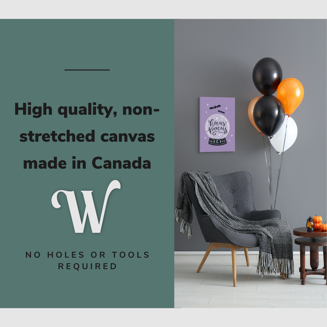 Lifestyle image of the vertical 16x24” inch easy to hang canvas wall art hung in a Halloween decorated living room above a reading chair with graphic saying "High quality, non-stretched canvas made in Canada."