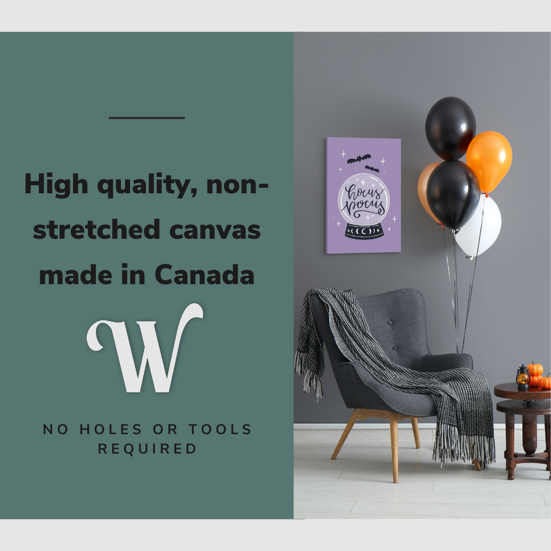 Lifestyle image of the vertical, 20x30” inch easy to hang canvas wall art hung in a Halloween decorated living room above a reading chair with graphic saying "High quality, non-stretched canvas made in Canada"