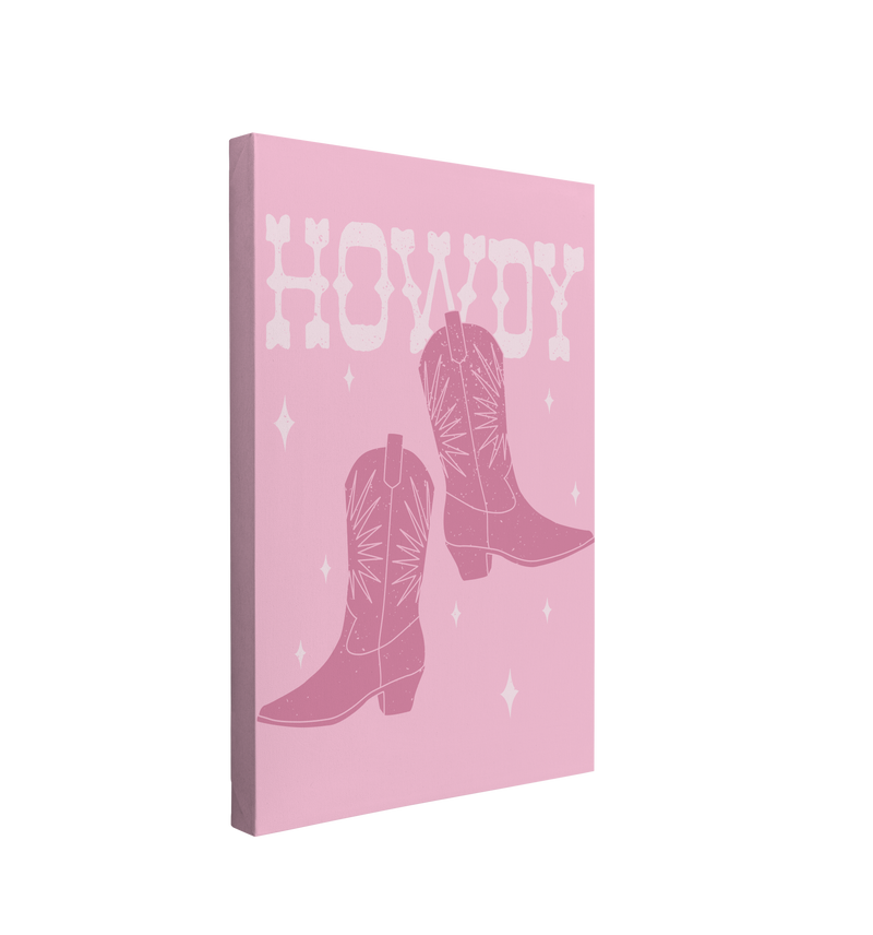 Single, 2:3 vertical easy to hang canvas print on a transparent background featuring an image of dark pink cowboy boots with "Howdy" written in a white western font behind the boots with white sparkles on a light pink background. 