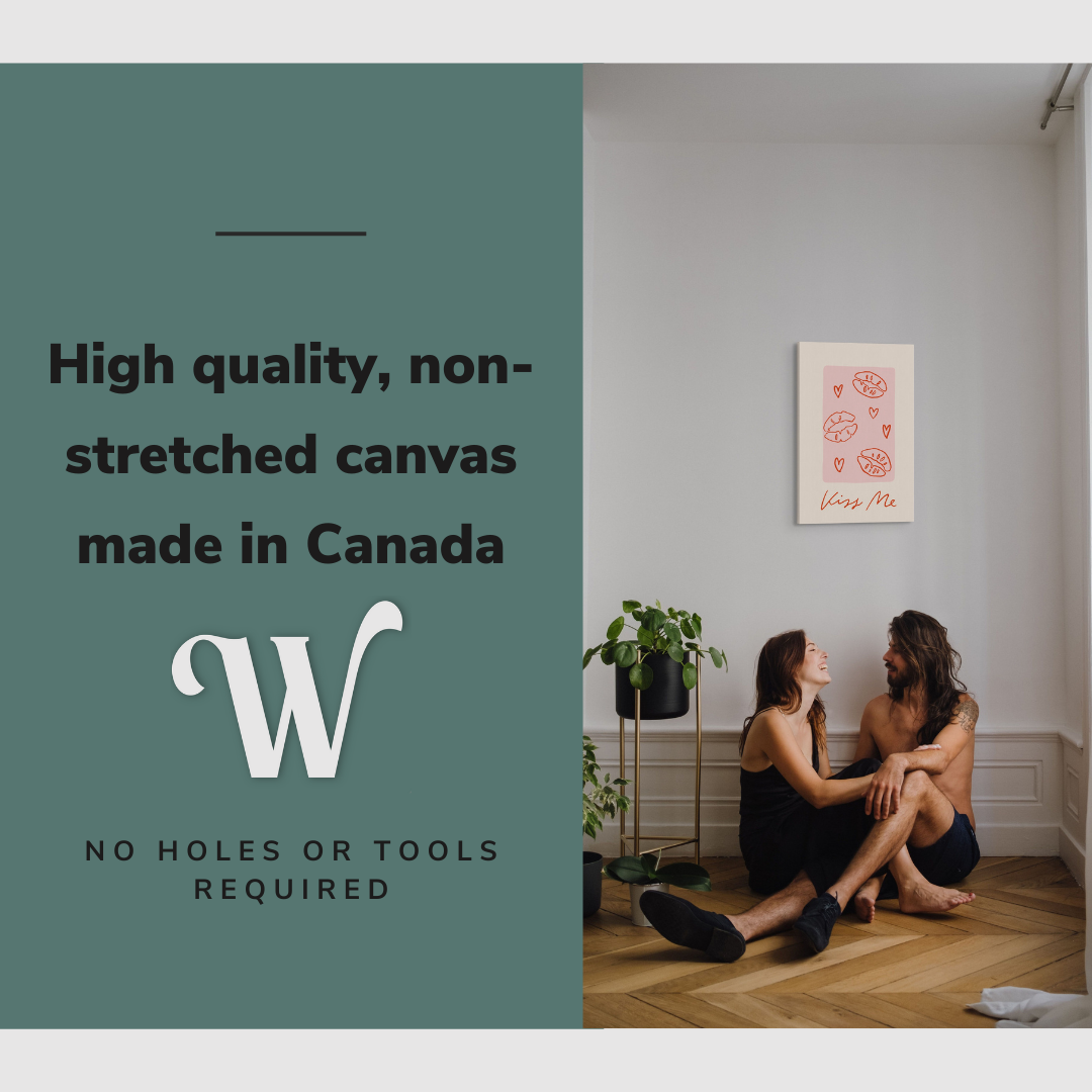 Lifestyle image of the vertical, 16x24 inch easy to hang canvas wall art hung in in a living room above a couple sitting on the ground with graphic saying "High quality, non-stretched canvas made in Canada"