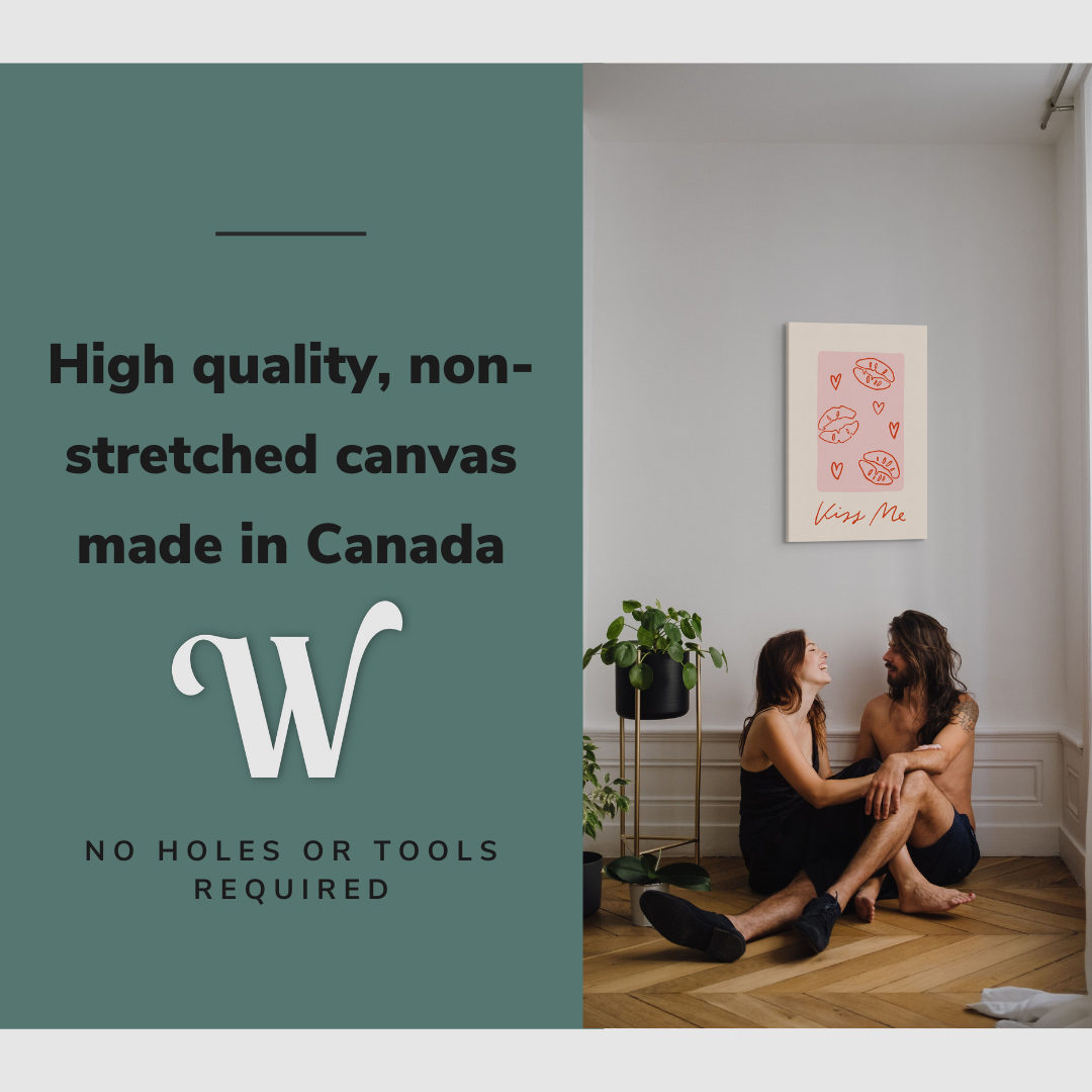 Lifestyle image of the vertical, 20x30 inch easy to hang canvas wall art hung in in a living room above a couple sitting on the ground with graphic saying "High quality, non-stretched canvas made in Canada"