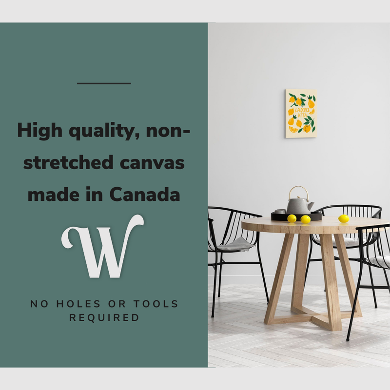 Lifestyle image of the vertical 12x18" inch easy to hang canvas wall art hung in a dining room above a dining table with lemons on it with graphic saying "High quality, non-stretched canvas made in Canada"