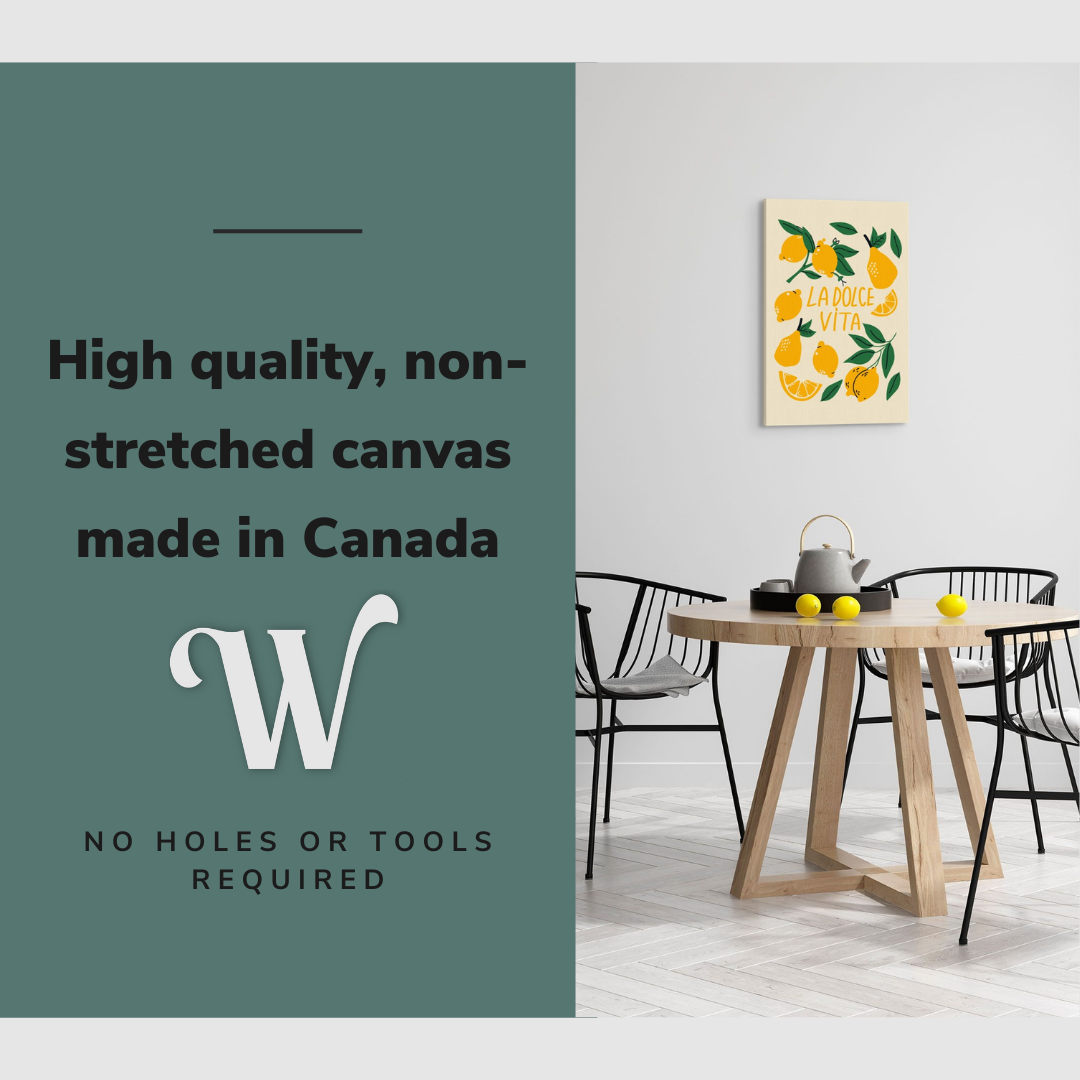 Lifestyle image of the vertical 20x30" inch easy to hang canvas wall art hung in a dining room above a dining table with lemons on it with graphic saying "High quality, non-stretched canvas made in Canada"