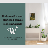 Lifestyle image of the vertical, 12x18 inch easy to hang canvas wall art hung in a hallway above a planter with graphic saying "High quality, non-stretched canvas made in Canada"