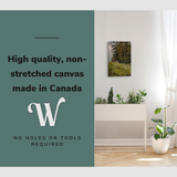 Lifestyle image of the vertical, 16x24 inch easy to hang canvas wall art hung in a hallway above a planter with graphic saying "High quality, non-stretched canvas made in Canada"