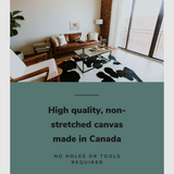 Lifestyle image of the horizontal 12x18” inch easy to hang canvas wall art hung in a western living room above a leather couch with graphic saying "High quality, non-stretched canvas made in Canada."