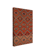 Single, 2:3 vertical easy to hang canvas print on a transparent background featuring an image of a red Navajo print from a blanket featuring a navy blue and white diamond patterning. 