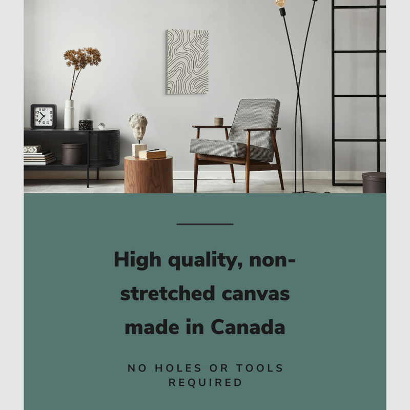 Lifestyle image of the vertical, 20x30 inch easy to hang canvas wall art hung in a living room above an accent chair and a coffee table with graphic saying "High quality, non-stretched canvas made in Canada"