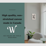 Lifestyle image of the vertical, 12x18 inch easy to hang canvas wall art hung in a living room above an accent chair and a coffee table with graphic saying "High quality, non-stretched canvas made in Canada"