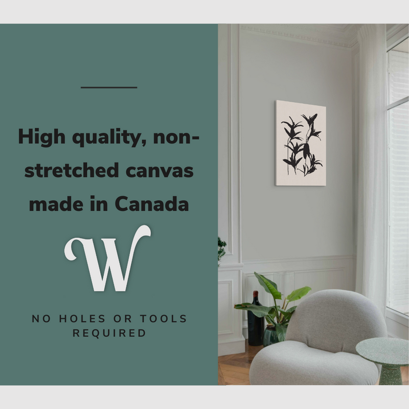 Lifestyle image of the vertical, 20x30 inch easy to hang canvas wall art hung in a living room above an accent chair and a coffee table with graphic saying "High quality, non-stretched canvas made in Canada"