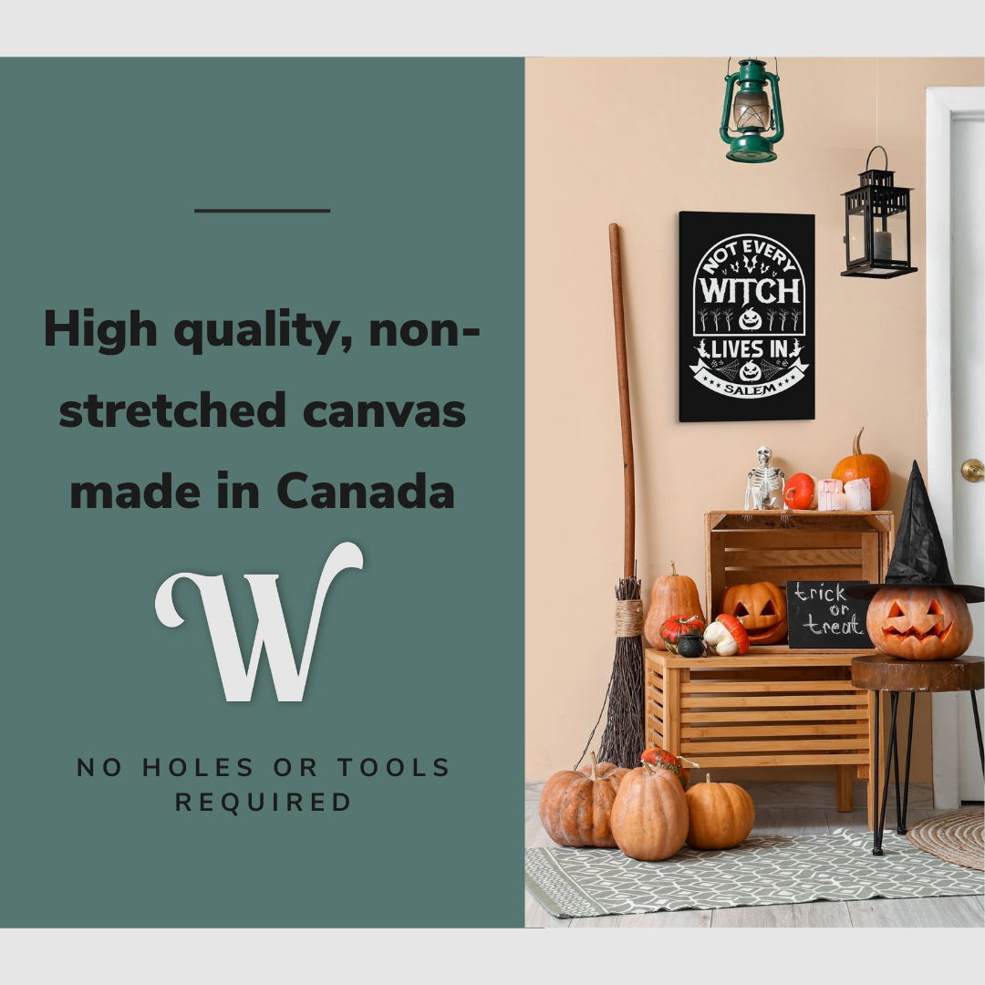 Lifestyle image of the vertical, 20x30” inch easy to hang canvas wall art hung beside a front door over some Halloween decorations with graphic saying "High quality, non-stretched canvas made in Canada"