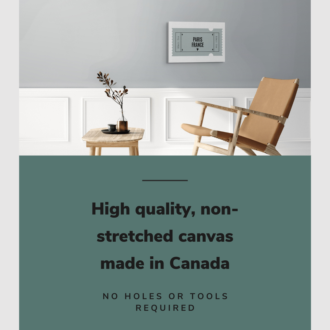 Lifestyle image of the horizontal 16x24” inch easy to hang canvas wall art hung in a living room above a chair and table with graphic saying "High quality, non-stretched canvas made in Canada."