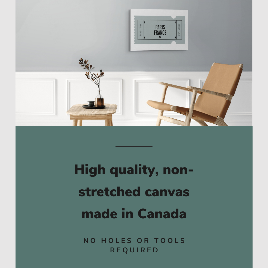 Lifestyle image of the horizontal, 20x30” inch easy to hang canvas wall art hung in a living room above a chair and table with graphic saying "High quality, non-stretched canvas made in Canada"