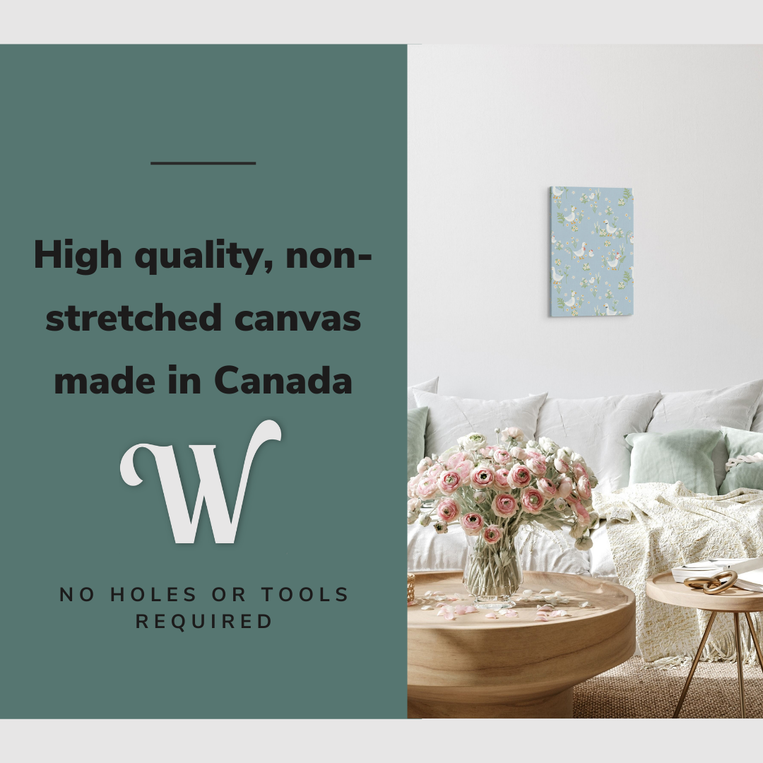 Lifestyle image of the vertical, 12x18 inch easy to hang canvas wall art hung in hung in an minimalist white living room above a big comfy couch with graphic saying "High quality, non-stretched canvas made in Canada"