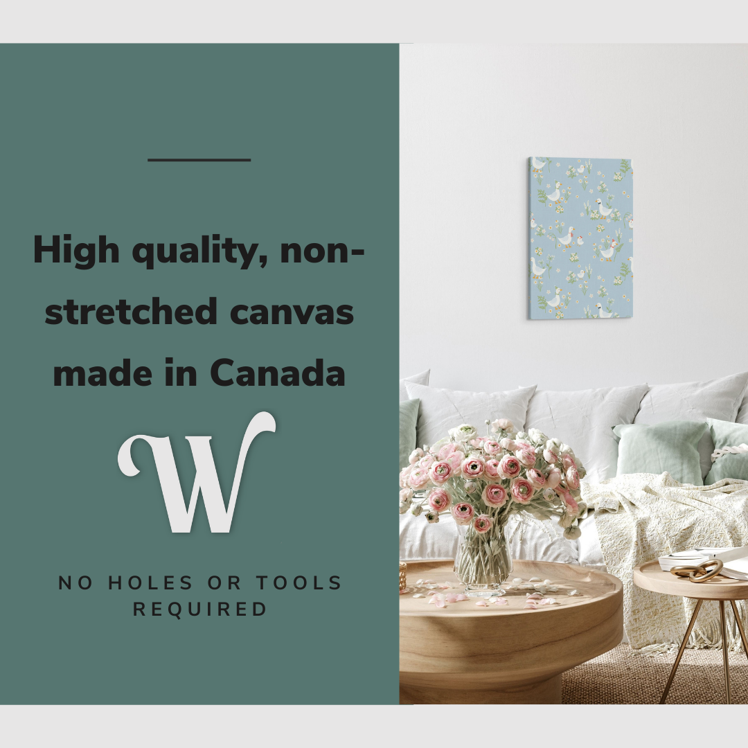 Lifestyle image of the vertical, 16x24 inch easy to hang canvas wall art hung in hung in an minimalist white living room above a big comfy couch with graphic saying "High quality, non-stretched canvas made in Canada"