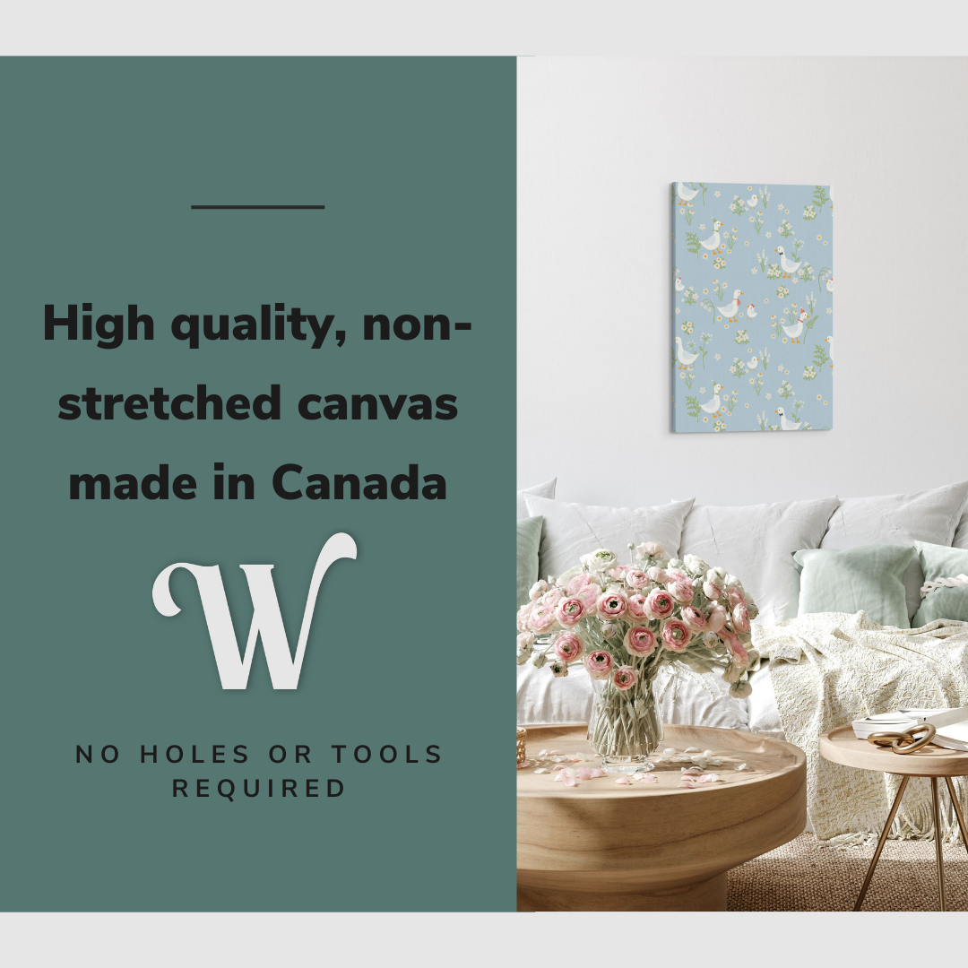 Lifestyle image of the vertical, 20x30 inch easy to hang canvas wall art hung in hung in an minimalist white living room above a big comfy couch with graphic saying "High quality, non-stretched canvas made in Canada"