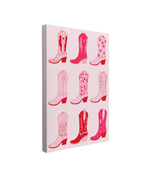 Single, 2:3 vertical easy to hang canvas print on a transparent background featuring an image of nine different pink cowboy boots on a light pink background.