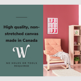 Lifestyle image of the vertical 16x24” inch easy to hang canvas wall art hung in a pink living room above a chair with graphic saying "High quality, non-stretched canvas made in Canada."