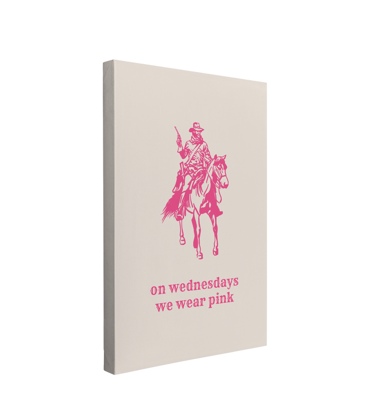 Single, 2:3 vertical easy to hang canvas print on a transparent background featuring an image of a minimalist pink cowboy riding a horse with his pistol drawn with vintage western font saying "on wednesdays we wear pink" underneath him on a beige background. 